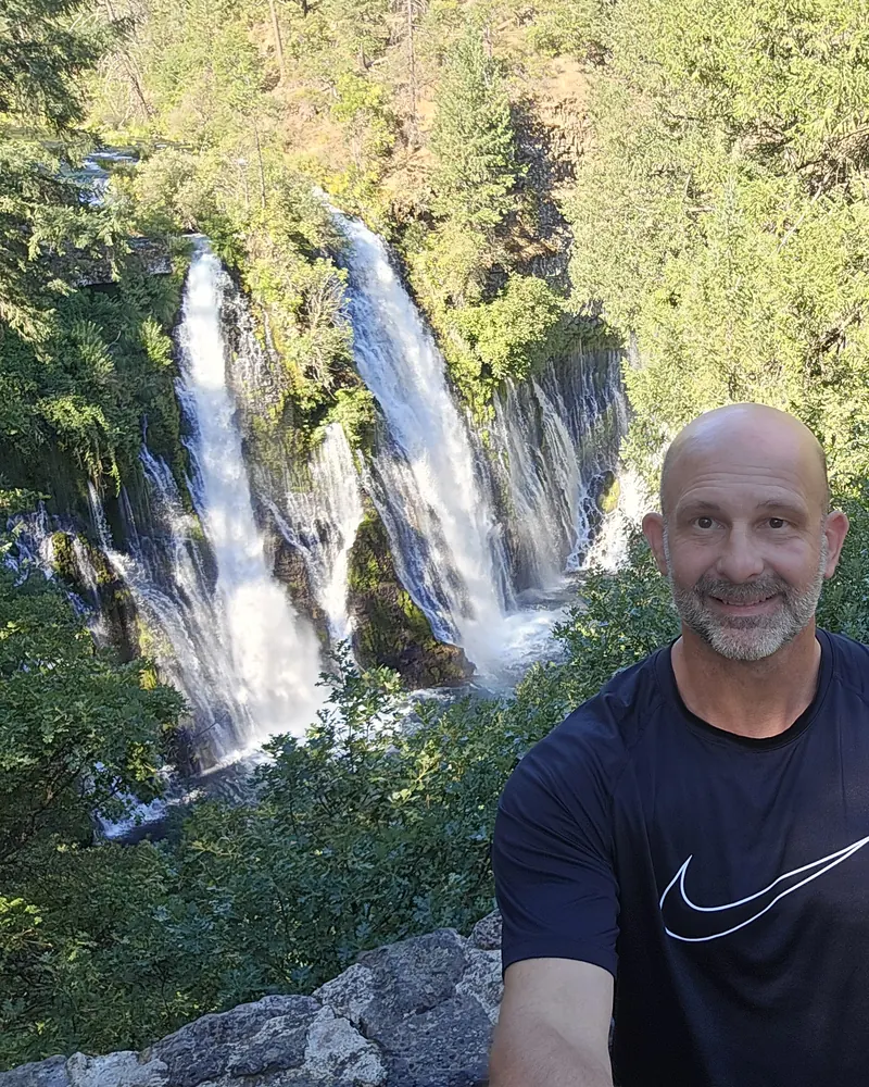 Andy, founder of Boltz Creations, at a waterfall
